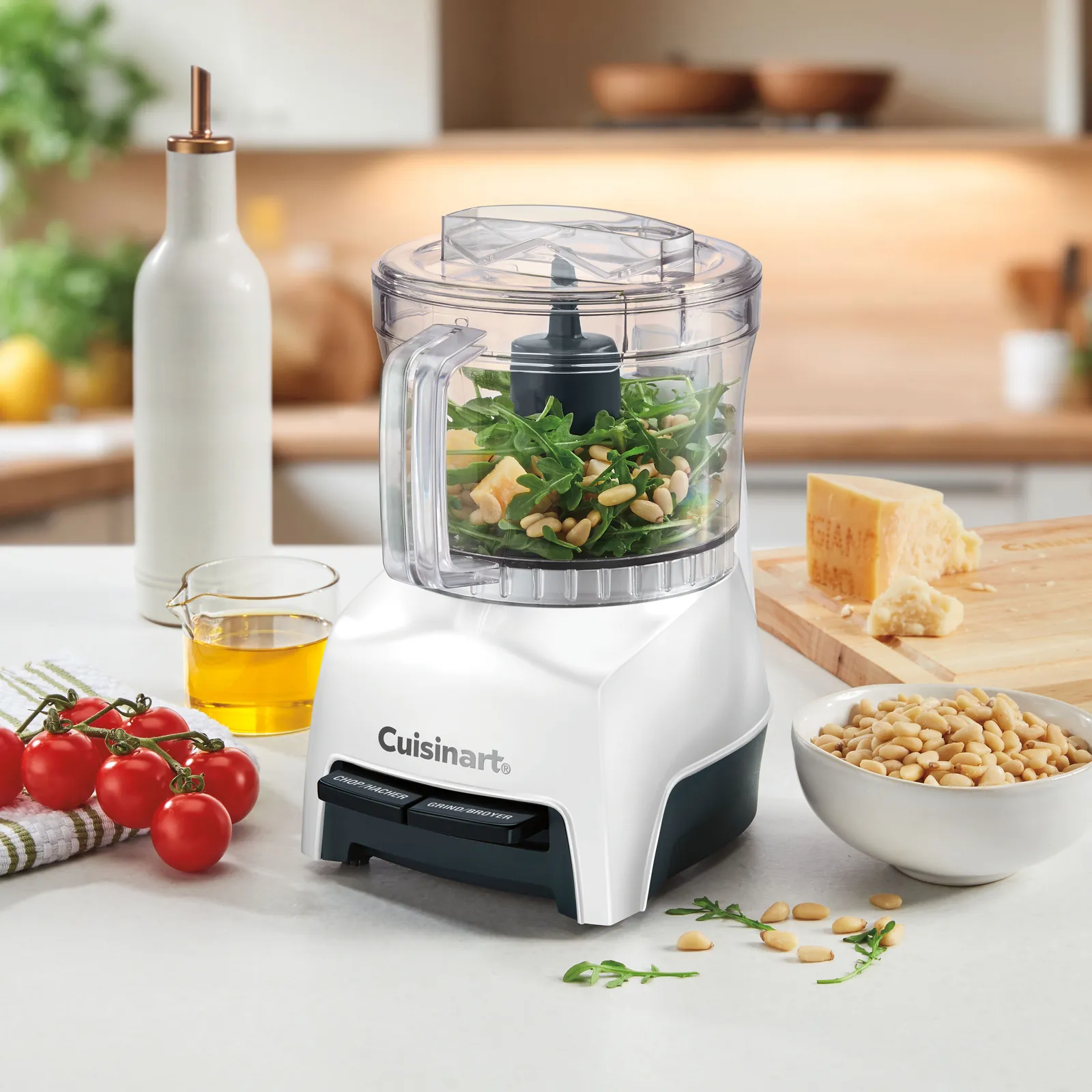 Clean food processor parts are neatly arranged on a drying mat after hand washing.