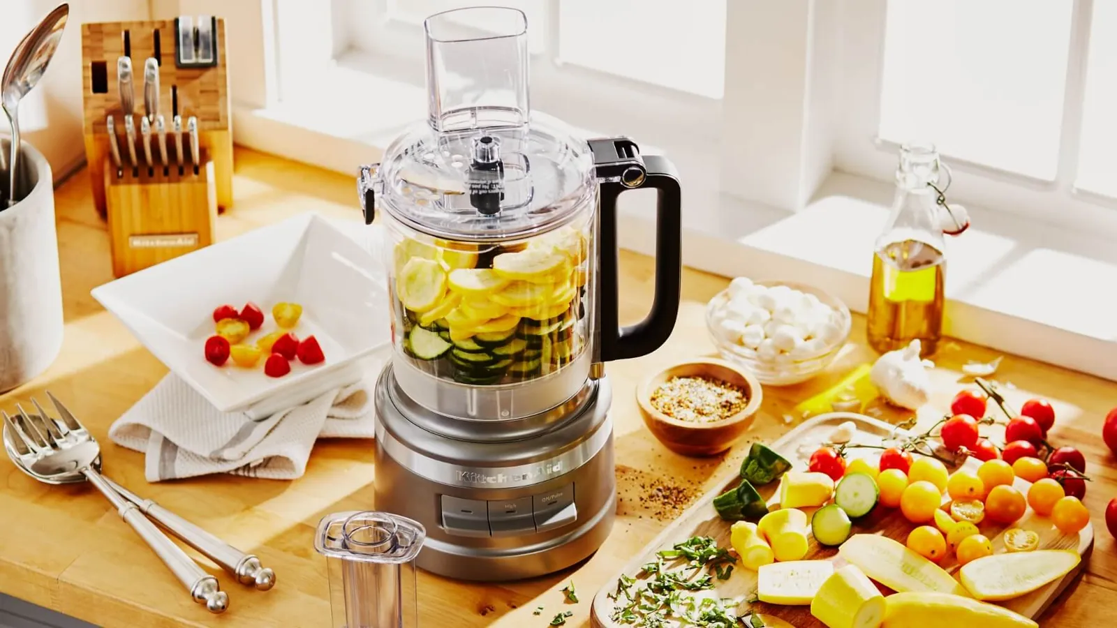 Freshly chopped vegetables and sliced cucumbers prepared using a versatile food processor.