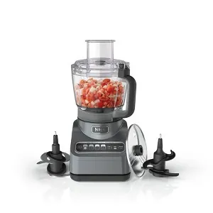 Plastic food processor components arranged safely on the top rack of a dishwasher.