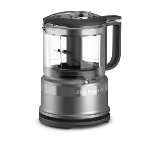 A warped plastic food processor bowl showing signs of heat damage.